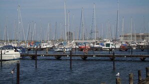 A marina with numerous sailboats docked at wooden piers. - Holiday apartment with balcony only 200 m to the Baltic Sea beach (Wendtorf)
