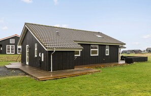 A single-story building with a dark exterior, a sloped roof, and a small porch. - Amazing home in Nordborg with sauna (Nordborg)