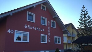 A red building with the text "Gästehaus" and "DIEBOLS" on its facade, indicating it is a guesthouse. - Gästehaus Alwin Diebold (Rust)