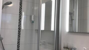 Shower, hair dryer, slippers, towels