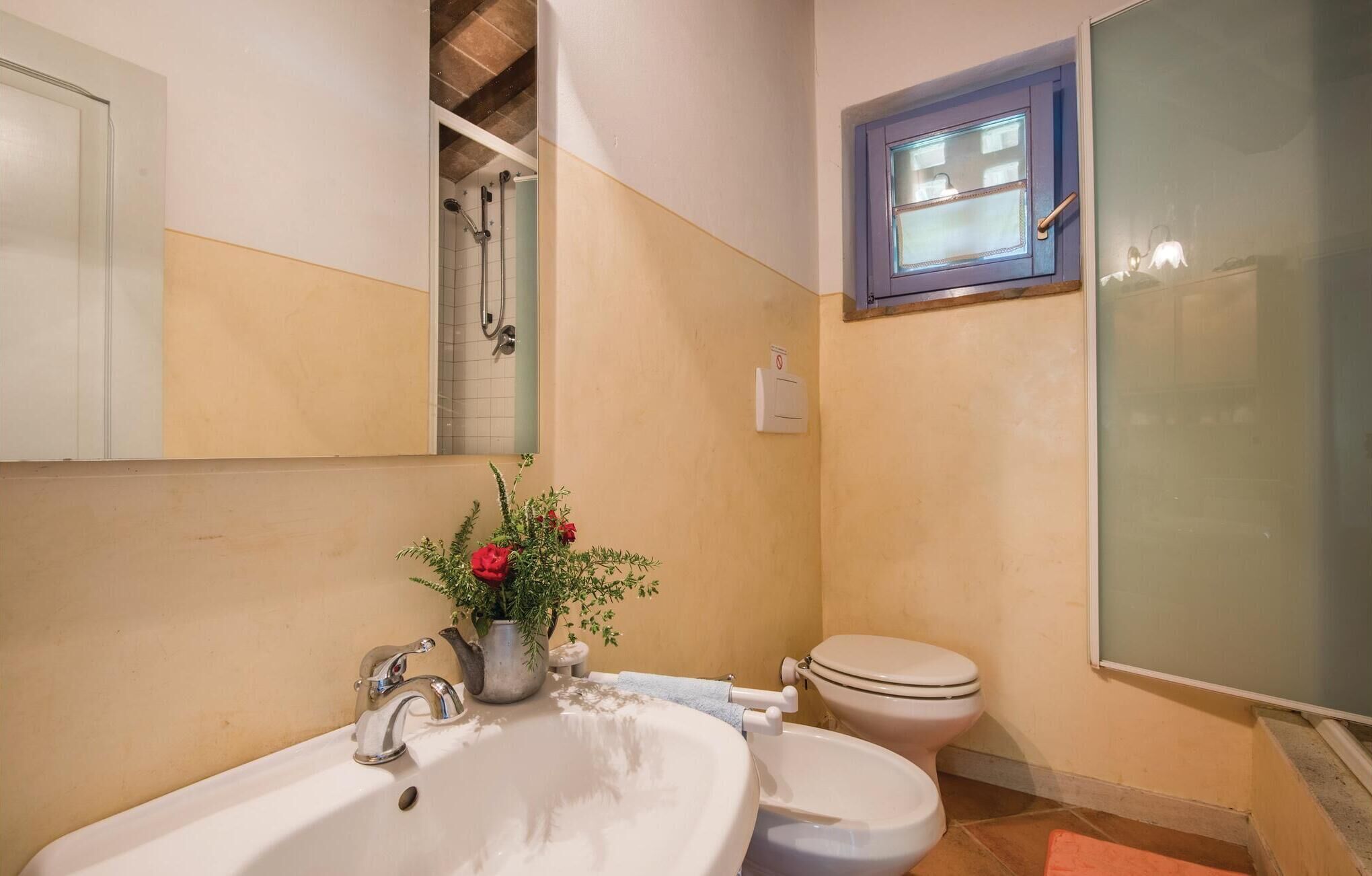 A bathroom with a sink, toilet, and shower.