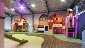 A play area with wooden structures and a slide. - Dünenvilla 19, Whg 4 (Travemünde Waterfront)
