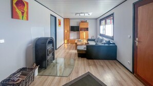A compact living space with a sofa, a television, and a fireplace. - 2 bedroom nice home in Oberelbert (Oberelbert)