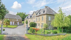 A stone building with a sloped roof, a paved driveway, and a sign indicating a historical site. - 2 bedroom amazing apartment in Ponts (Ponts)