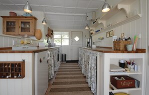 Kitchen with central island, pendant lights, and a window for natural light.