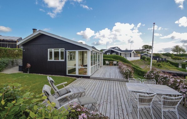 Relax in a spacious deck surrounded by lush greenery and comfortable seating areas.