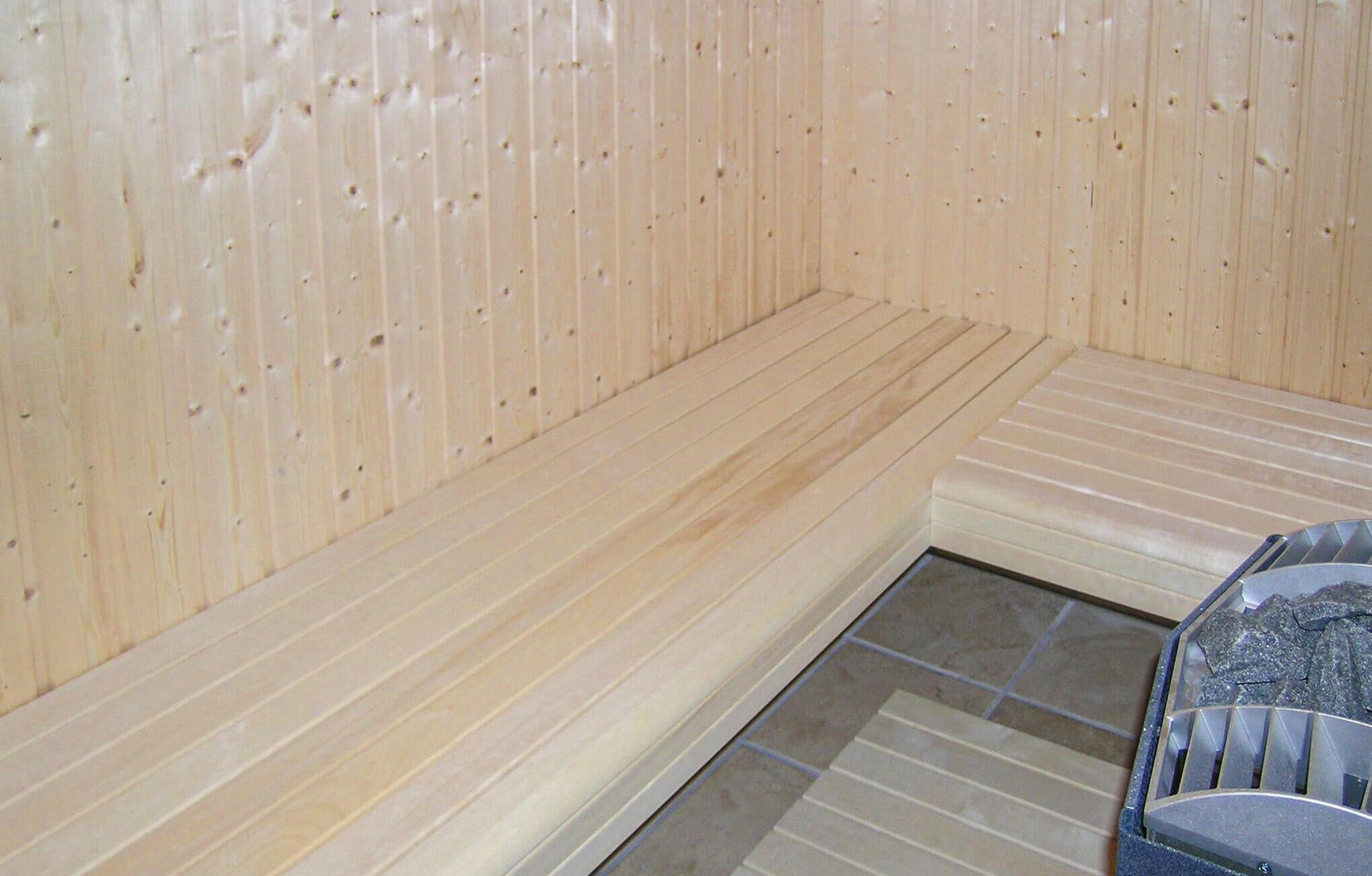 A sauna with wooden walls and benches.