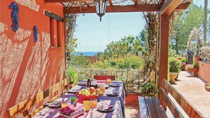 An outdoor dining area with a table set for breakfast, overlooking a scenic view. - Beautiful apartment in Palamós (Palamós)