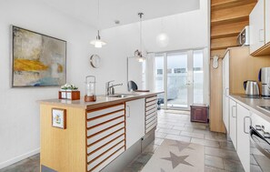 Fridge, stovetop, dishwasher, coffee/tea maker