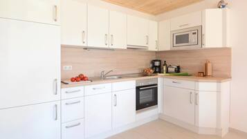 Fridge, stovetop, dishwasher, coffee/tea maker