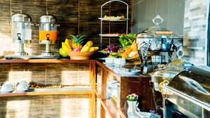 A buffet setup with various food items and serving equipment. - Baan Chankaew Hotel (Ko Pha-ngan)