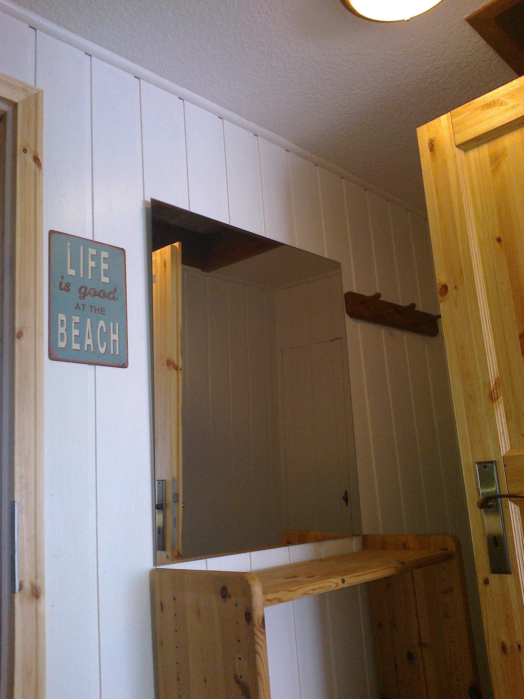 A wooden interior with a sign stating 'LIFE is good at the BEACH'.