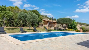 A swimming pool with lounge chairs, a stone deck, and a rustic house in the background. - Awesome home in Sineu (Sineu)