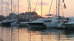 A marina with multiple sailboats docked.
