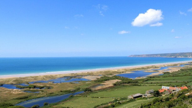 A coastal landscape with a beach, water bodies, and scattered houses. - 2 bedroom amazing home in LA HAGUE (LA HAGUE)