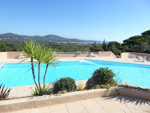 A swimming pool with a view of mountains and a clear sky.