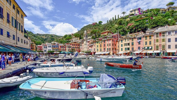 A marina with boats docked, surrounded by colorful buildings and a hillside. - Cozy apartment in Rapallo GE with WiFi (Rapallo GE)