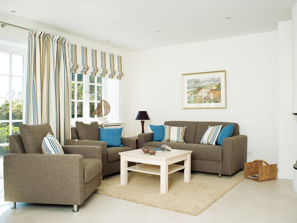 A living room with a sofa set, a coffee table, and a lamp.