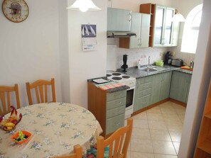 Enjoy cooking in this well-equipped kitchen with a central island, stove, and sink.