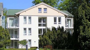 A multi-story residential building with a symmetrical facade, large windows, and a central entrance. - Beach Park Heringsdorf - near the beach / first row - apartment 3. 24 (Heringsdorf)