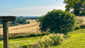 A rural landscape with a stone post, a large bush, and a field of crops. - Gorgeous home in St.Aubin de Cadelech (St.Aubin de Cadeleche)
