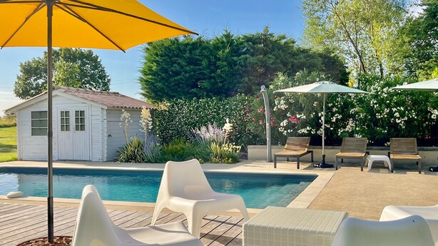 A pool area with white plastic chairs, a wooden deck, and a small shed. - Gorgeous home in St.Aubin de Cadelech (St.Aubin de Cadeleche)