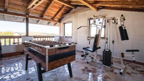A room with a foosball table, exercise equipment, and a view through large windows. - Pet friendly home in Ozalj (Ozalj)