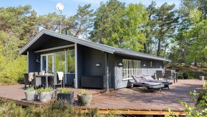 A modern cabin with a deck, outdoor seating, and a satellite dish. - 2 bedroom amazing home in Nexø (Nexø)