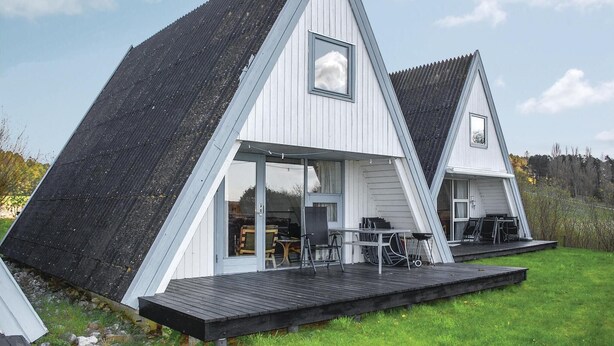 A modern, triangular house with a large deck and a covered outdoor area. - 3 bedroom lovely home in Knebel (Knebel)
