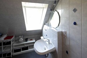 Shower, hair dryer, soap, toilet paper