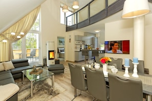 A modern living room with a glass coffee table, grey sofas, and a fireplace. - Kapitänsweg 2 cabin 07 (5 *) - Usedom tour operator Karlshagen - Kapitänsweg 2 cabin 07 (5 *) (Karlshagen)