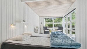 A bedroom with two beds, a window, and a view of the outdoors. - 3 bedroom beautiful home in Nexø (Nexø)