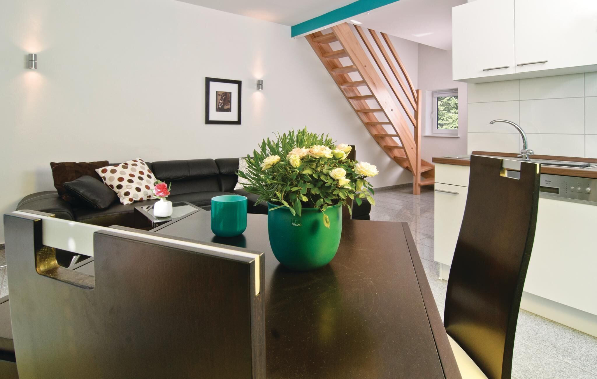 A modern kitchen with white cabinets and a dishwasher.