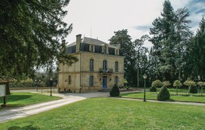 A two-story building with a symmetrical facade, a central entrance with steps, and a flag on the second floor. - Cozy home in Saint - Agne (Saint - Agne)