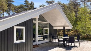 A modern house with a deck, large windows, and outdoor furniture. - Beautiful home in Nexø with WiFi (Nexø)
