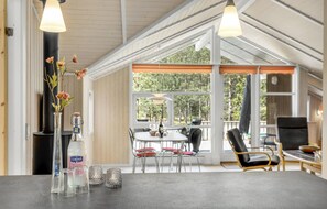 Enjoy meals with family and friends in this spacious dining area, featuring a large table and comfortable seating.