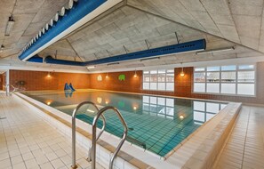 Swim laps in the pool surrounded by a brick-lined area with stairs leading in.
