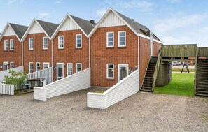 Three charming homes with gabled roofs and front porches.