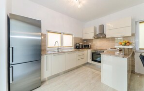 Fridge, stovetop, dishwasher, coffee/tea maker