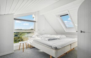 A bedroom with a bed, a small stool, and a skylight. - Gorgeous home in Thisted with sauna (Thisted)