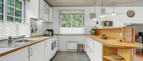 Fridge, stovetop, dishwasher, coffee/tea maker