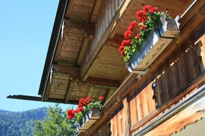 A wooden building with balconies and flower boxes.