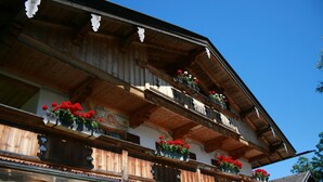 Un bâtiment traditionnel en bois, doté de balcons et de jardinières.