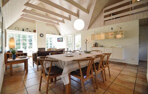 Enjoy meals in this dining area with a long table and comfortable seating for six.