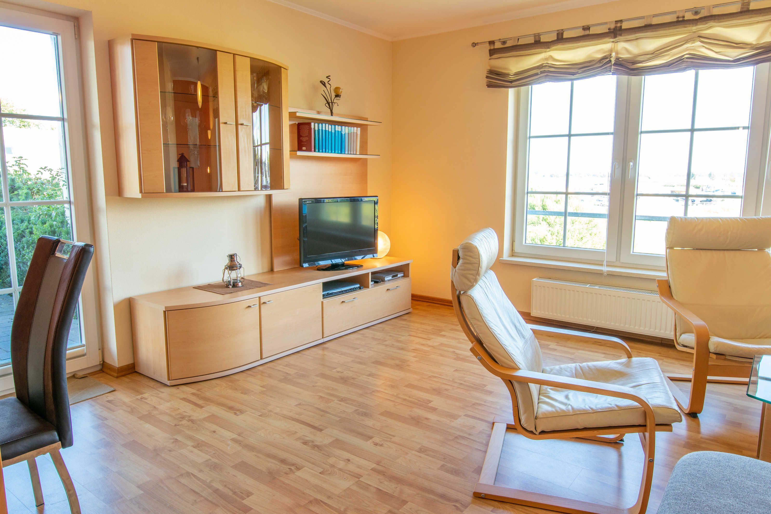 A living room with a TV, sofa, and a cabinet.