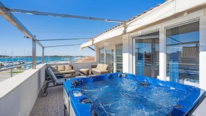 A rooftop terrace with a hot tub, seating area, and a view of the marina. - Lovely home in Murter with WiFi (Murter)