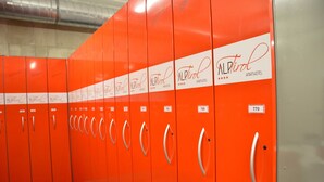 A row of orange lockers with the 'AlpTril' logo and room numbers visible. - Double room Hochzillertal 2 - Aparthotel **** AlpTirol (Kaltenbach)