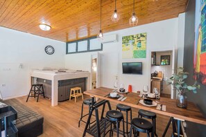 A modern kitchen with a central island, bar stools, and a dining table. - Holiday apartment only 250 m from the sandy beach of the Golden Shore (Siófok)