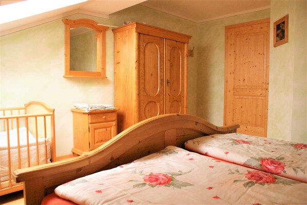Un dormitorio con una cama, un armario y un aparador de madera.