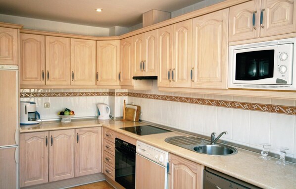 Fridge, stovetop, dishwasher, coffee/tea maker